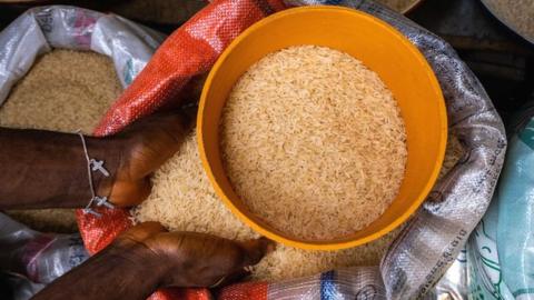 A trader selling rice in a market in Lagos, Nigeria