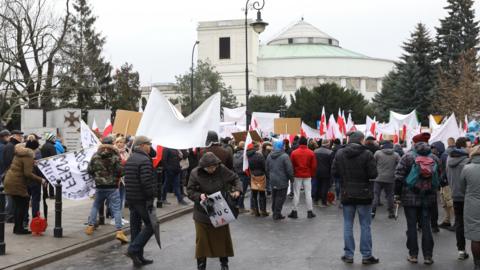 People take part in a demonstration in front of parliament to protest against the reform of the judiciary in Warsaw, Poland, 8 December 2017