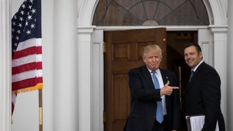 Trump stands next to Kris Kobach