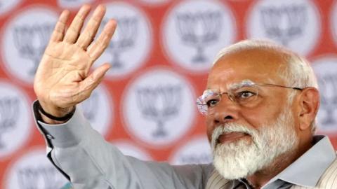 India's Prime Minister Narendra Modi greets his supporters during an election campaign rally in Pushkar on April 6, 2024, ahead of the country's upcoming general elections. (Photo by HIMANSHU SHARMA / AFP) (Photo by HIMANSHU SHARMA/AFP via Getty Images)