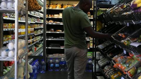 A man shopping in a convenience store in South Africa