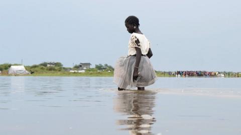 A girl walks in water after heavy rains and floods forced hundreds of thousands of people to leave their homes, in the town of Pibor, Boma state, South Sudan, November 6, 2019.Picture taken November 6, 2019