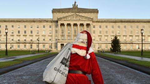 Santa Claus walking towards Parliament Buildings at Stormont