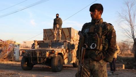 Afghan security officials inspect the scene of a bomb attack in Herat, Afghanistan, 20 January 2021