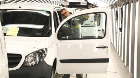 A man assembles a car at Renault's factory in Maubeuge, France