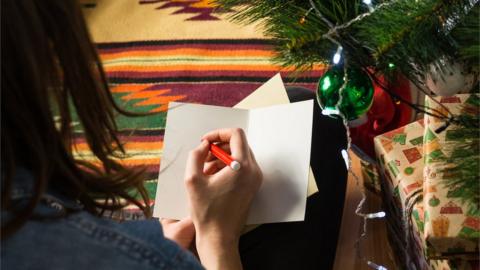 Girl writing Christmas card
