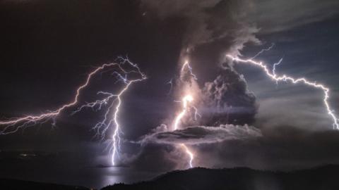 Lightning strikes as a column of ash surrounds the crater of Taal Volcano as it erupts on January 12