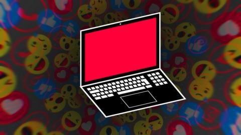 A laptop with a red screen against a background of emojis