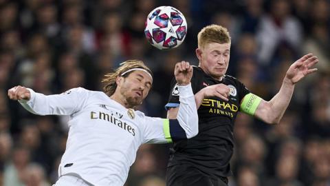 Real Madrid's Sergio Ramos (left) and Manchester City's Kevin de Bruyne (right) jump to try to head the ball