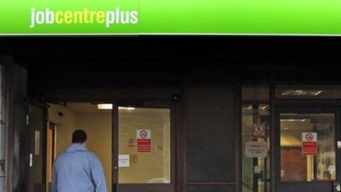 woman with pushchair and man walking into a job centre