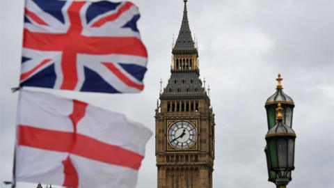 Union flag and St George's Cross flying outside Parliament