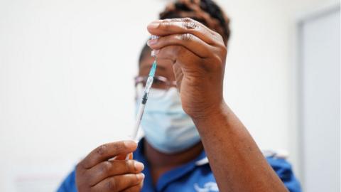 A nurse prepares a Covid vaccine during the spring booster campaign