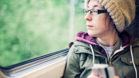 A woman looking out of a train window