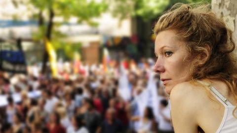 A woman watches a demonstration