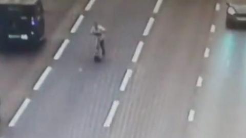 Man rides scooter on motorway