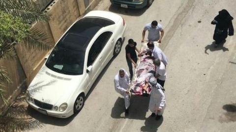 Photograph showing what activists say is an injured protester being carried on a stretcher after a police raid on a sit-in in Diraz on 23 May 2017