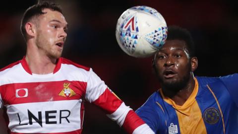 Jon Taylor of Doncaster Rovers (left) and Aaron Pierre of Shrewsbury Town