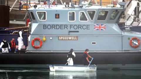 Border Force team with a small rowing boat