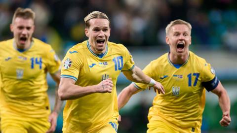 Ukraine players celebrate beating Iceland