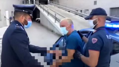 Giuseppe Mastini is returned to police custody after escaping prison