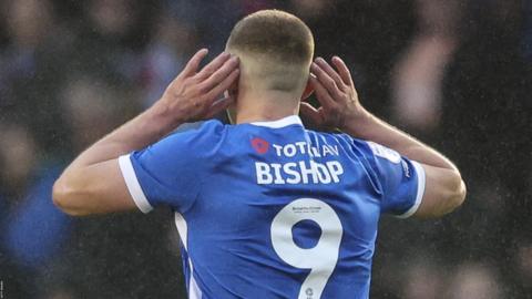 Colby Bishop cups his ears to the crowd