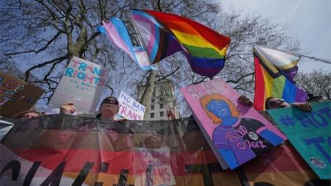 People take part in a demonstration outside Downing Street in London, to protest against the exclusion of transgender people from a ban on conversion therapy