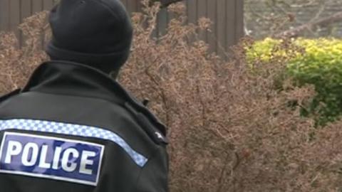 A policeman outside a property in Blackbird Leys