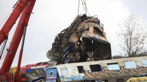 Remains of destroyed train carriage being removed by crane on Thursday morning