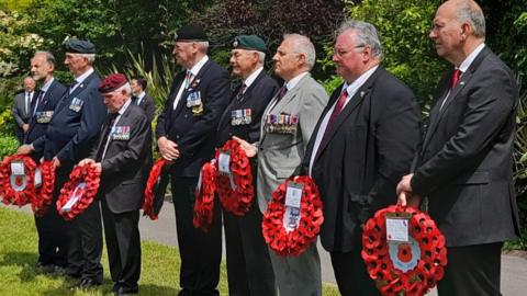 Veterans holding wreathes