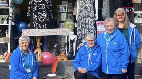 Volunteers and staff at the information point and charity shop