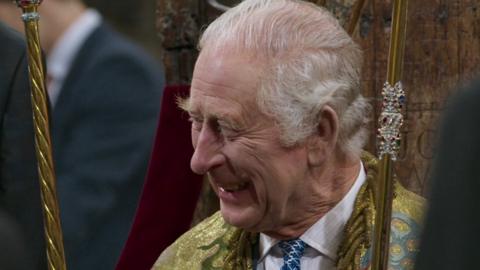 King Charles laughs