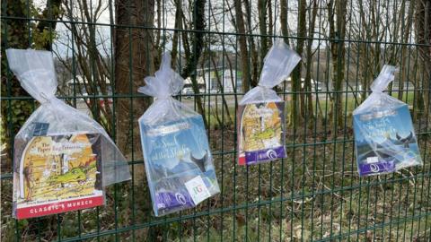 Books tied to fence