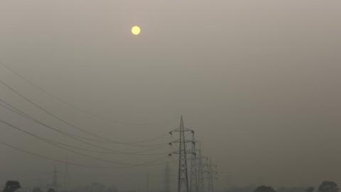 High tension electric pylons are pictured on a smoggy day in New Delhi, India, November 30, 2015