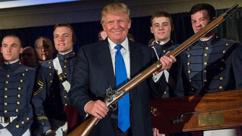 Donald Trump holding a long gun