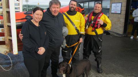 John Muldowney and his dog Riley pictured with their rescuers
