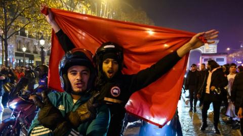 Moroccan supporters celebrate victory as Morocco qualified for 2022 FIFA World Cup quarterfinals after beating Spain on penalties during the FIFA World Cup