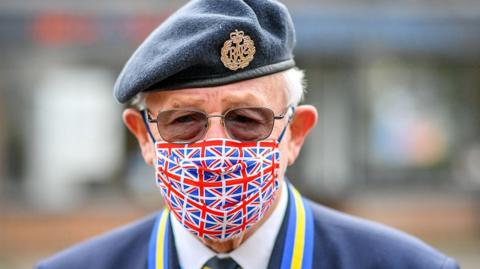 Ex RAF serviceman Tom Blundell wears a Union flag mask