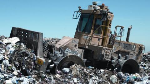 File image of a rubbish compactor at a landfill site