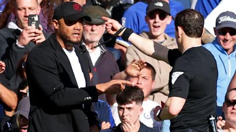 Vincent Kompany is shown a red card by referee Darren England