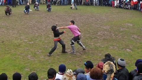 People fighting in a circle