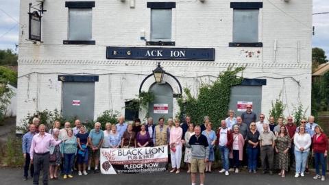 Villagers outside the Black Lion pub, in Skelton-on-Ure