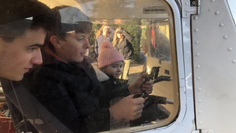 James showing students the plane