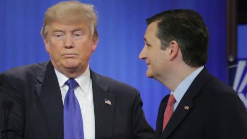 Donald Trump and Ted Cruz shake hands at a Republican debate.