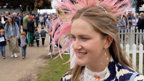 A decoratively dressed woman attends the Suffolk Show
