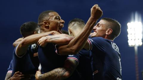 Paris St Germain's Kylian Mbappe (centre) celebrates with team-mates after scoring at Brest