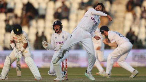 Joe Root throws the ball up in celebration after catching Imam-ul-Haq