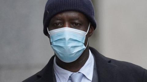 Image of Stephen Kyere wearing a navy blue hat and mask.