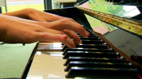 Close Up of Hands Playing Piano