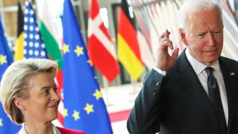 U.S. President Joe Biden crosses his fingers next to European Commission President Ursula von der Leyen as they attend the EU-US summit, in Brussels, Belgium June 15, 2021