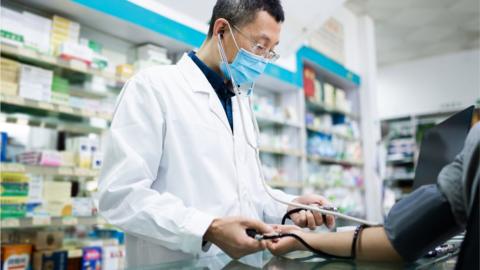 Pharmacist doing a blood pressure check